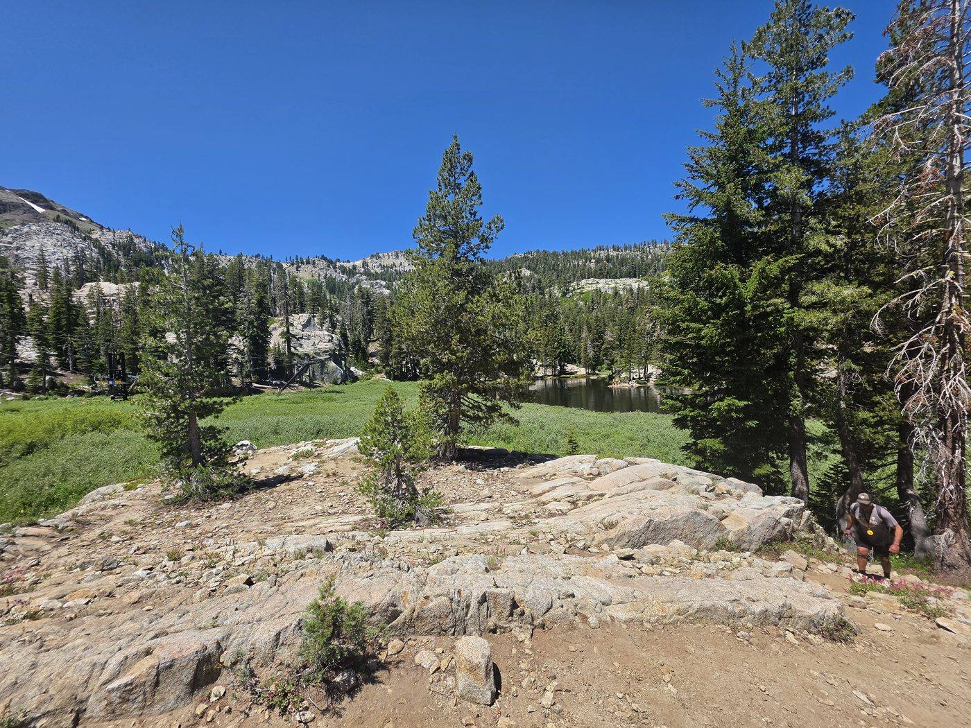 Alpine lake and granite slabs on the trail above Olympic Valley