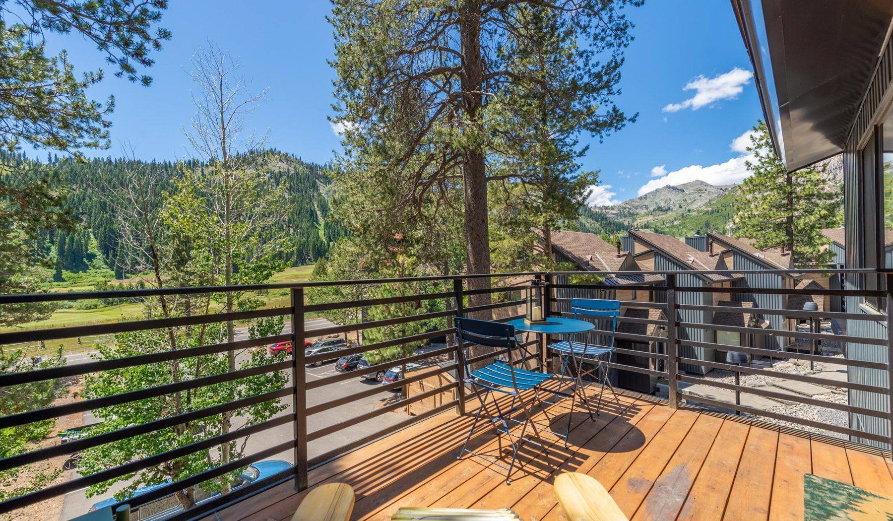The private deck at Alpenglow Loft looking out across Olympic Valley toward the Sierra peaks